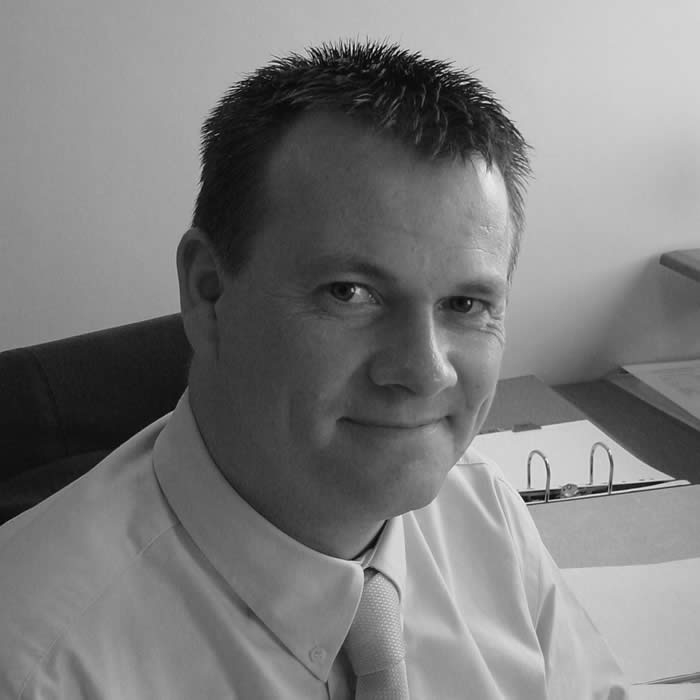 Portrait photograph of Darren Hills